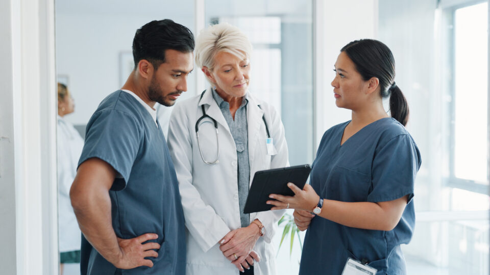 Doctor and nurses looking at tablet