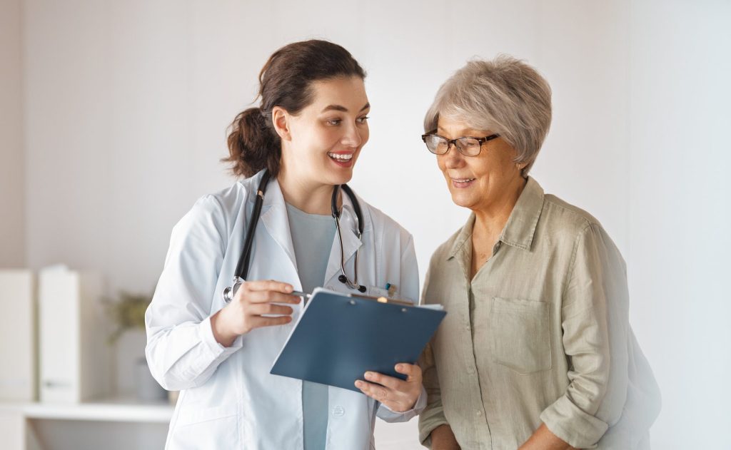 Female patient listening to a doctor in hospital.